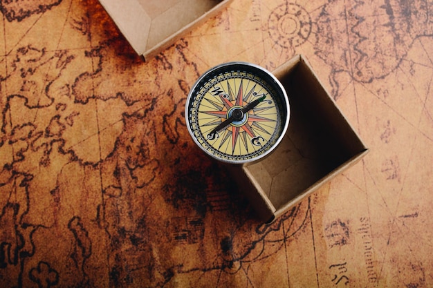 Compass beside a box on a map as concept of traveling