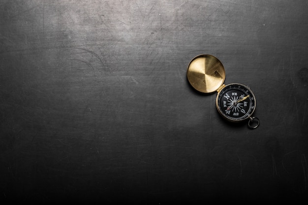 Compass on black board background