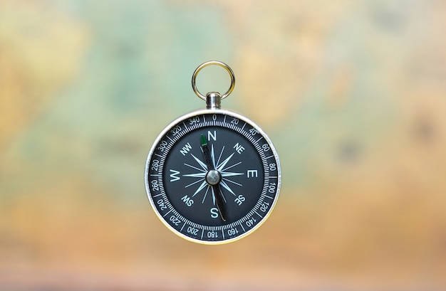 Compass on a blurred background of an old map