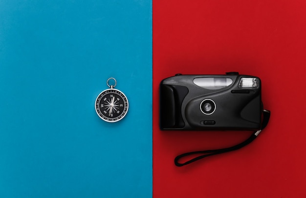 Compass and camera on a red-blue