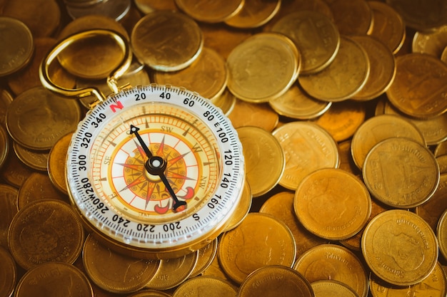 Compass and gold coin money for business financial concept.