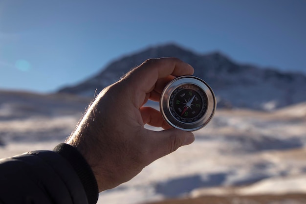 compass in man hand nature background