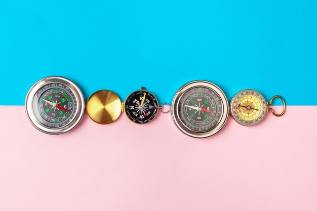 Compass on pink and blue, top view