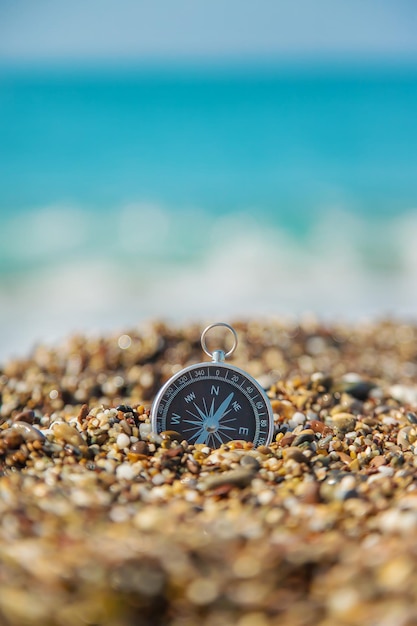 Compass on the sea beach. Selective focus.