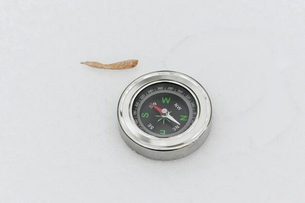 Photo a compass in the snow