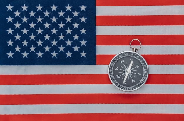 Compass on USA flag close up. Top view