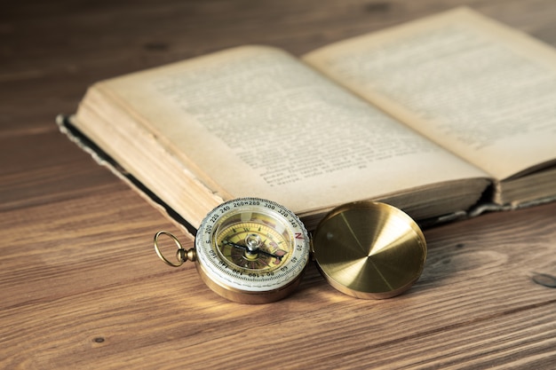 Photo compass with a book on the table