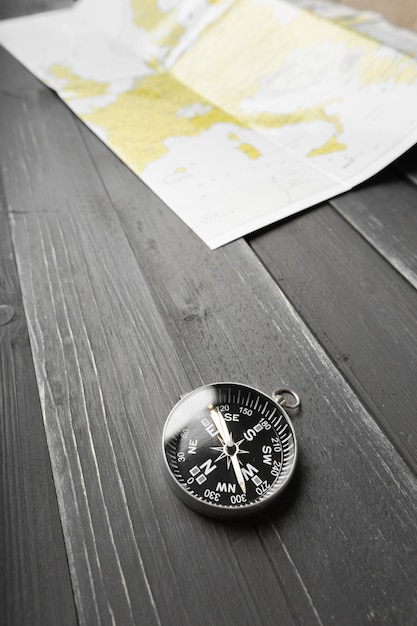 Photo compass on the wooden table background