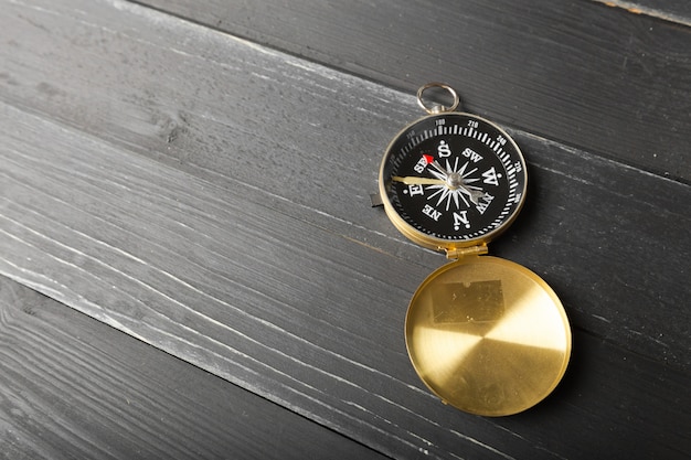 Photo compass on the wooden table