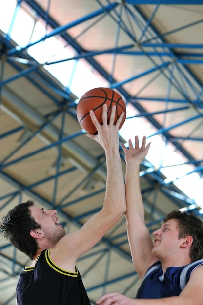 competition cencept with people who playing basketball in school gym