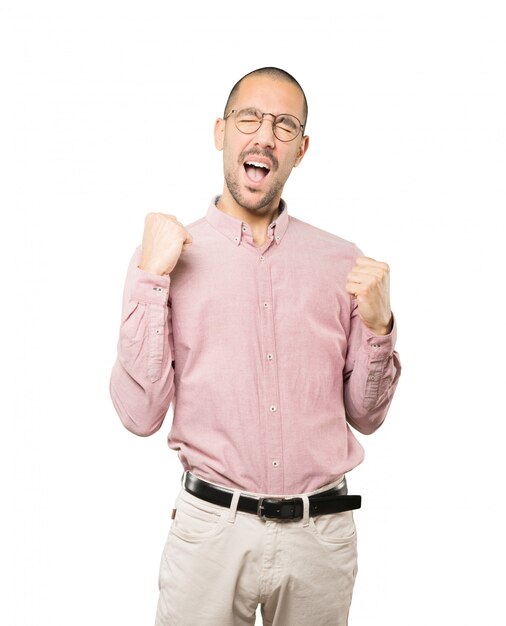 Photo competitive young man making a gesture of celebration