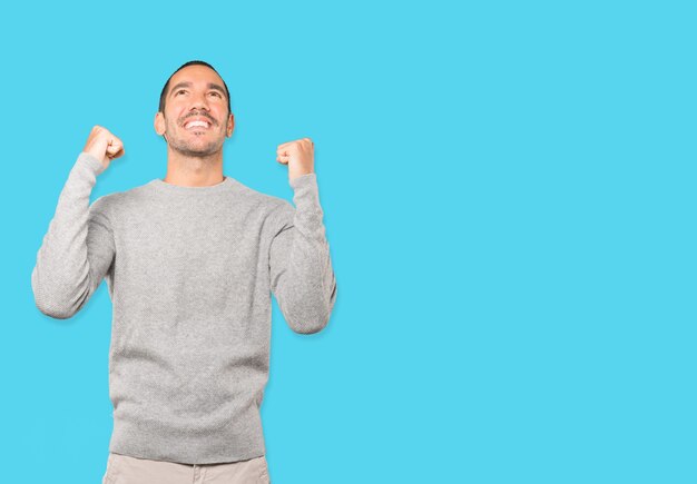 Competitive young man making a gesture of celebration