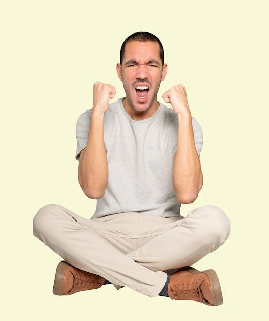 Competitive young man making a gesture of celebration