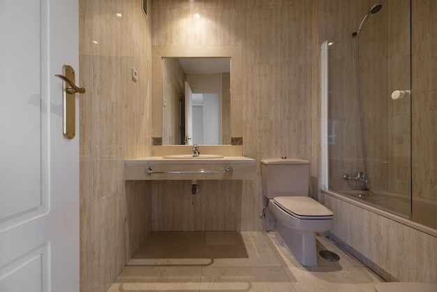 Complete bathroom of a house with a mirror with a marble frame