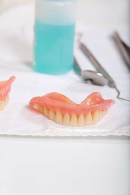 Complete denture on a stomatological table. Closeup