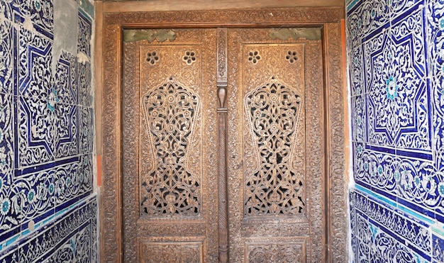 Complex carved wooden ornament on the doors