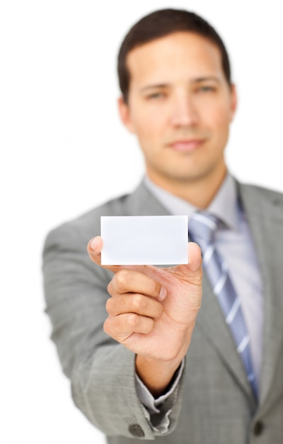 Composed young businessman holding a white card 