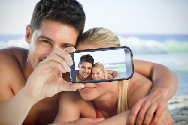 Composite of Couple taking selfie on smartphone