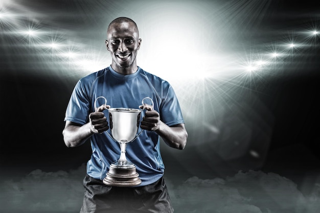 Composite image 3D of portrait of happy athlete holding trophy