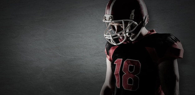 Composite image of american football player standing in rugby helmet