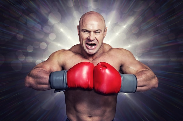 Composite image of angry bald boxer with punching gloves