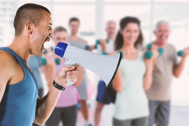 Composite image of angry male trainer yelling through megaphone