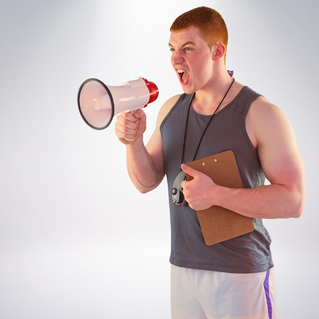 Composite image of angry personal trainer yelling through megaphone