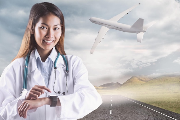 Composite image of asian doctor using her smart watch