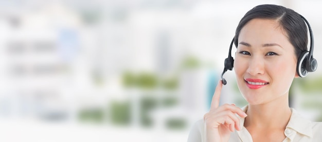 Composite image of beautiful smiling female executive with headset