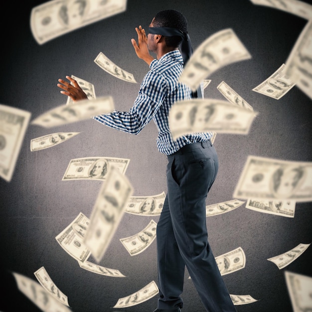 composite image of blindfolded businessman with arms out