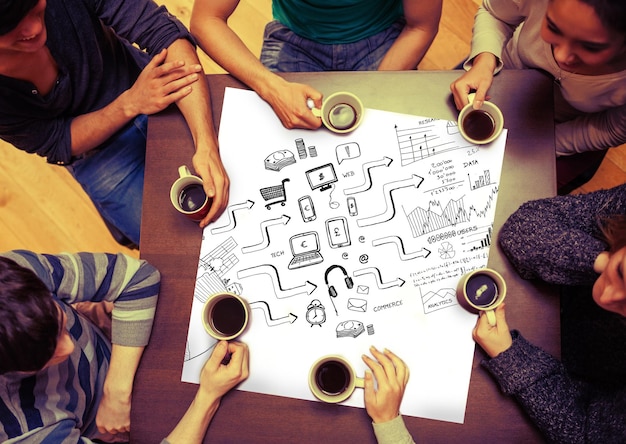 Composite image of brainstorm graphic on page with people\
sitting around table drinking coffee