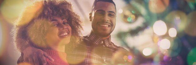 Photo composite image of brown parquet against millennial adult couple celebrating christmas together at home