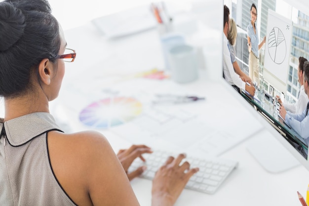 Composite image of business people in office at presentation