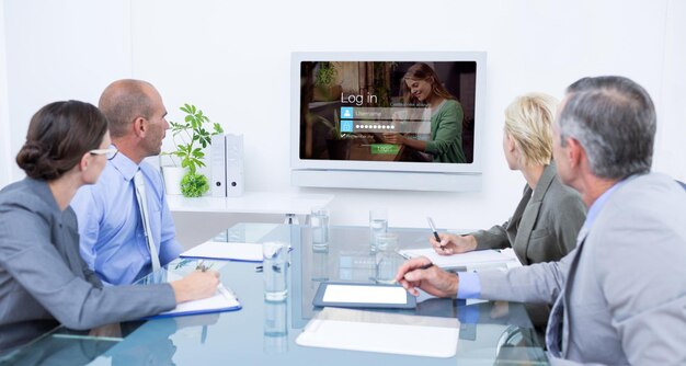 Composite image of business team looking at time clock