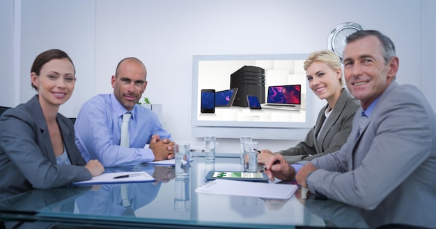 Composite image of business team looking at white screen