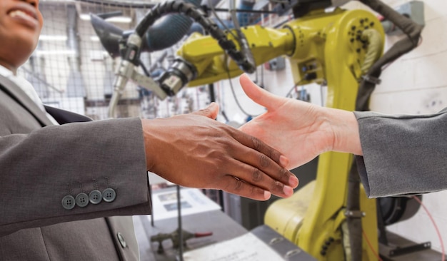 Composite image of businessman going shaking a hand