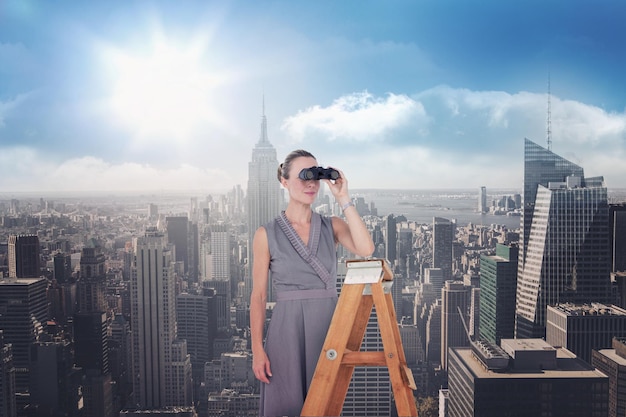 Composite image of businessman looking on a ladder