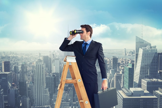 Composite image of businessman looking on a ladder