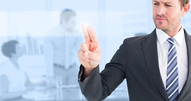 Composite image of businessman pointing with his finger