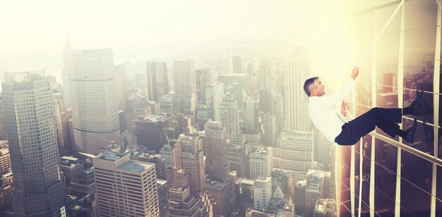 Composite image of businessman pulling rope while sitting on cube