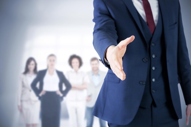 Composite image of businessman ready to shake hand