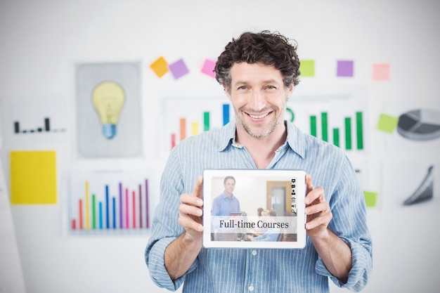 Composite image of businessman showing digital tablet with blank screen in creative office