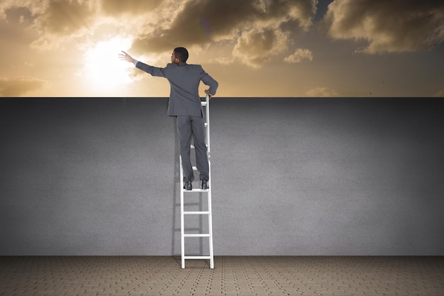 Composite image of businessman standing on ladder