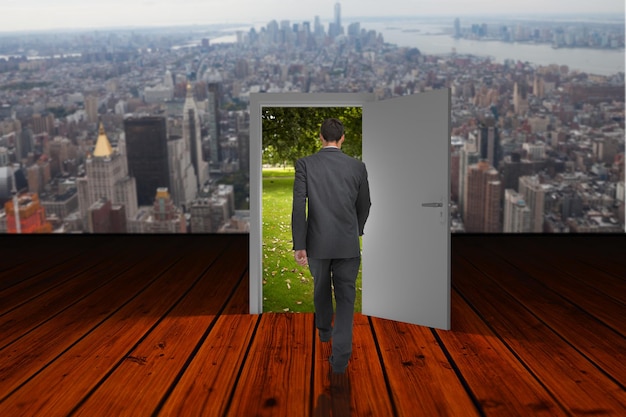 Composite image of businessman walking