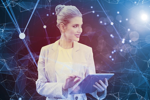 Composite image of cheerful stylish businesswoman using digital tablet