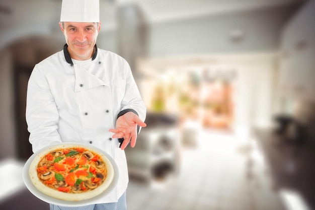 Composite image of chef displaying delicious pizza