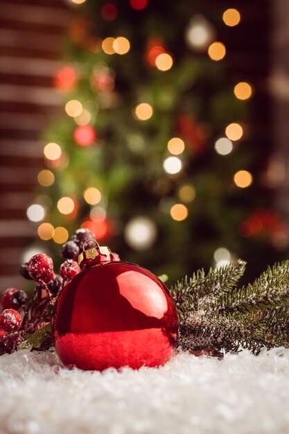 Composite image of Christmas bauble and holly