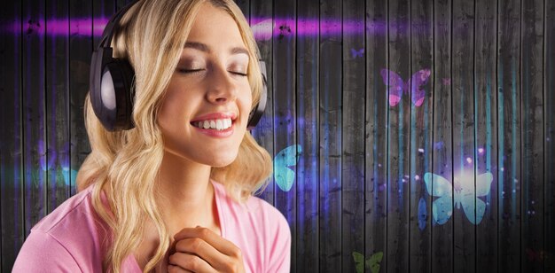 Composite image of close up of a woman listening to music