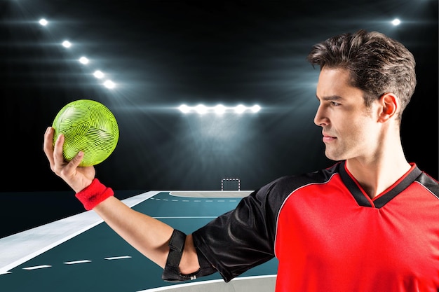 Composite image of confident athlete man holding a ball