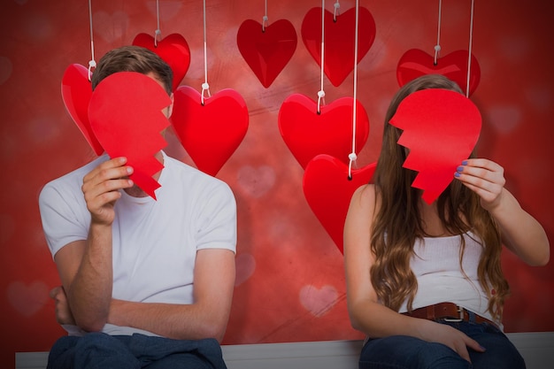 Composite image of couple holding broken heart 3d